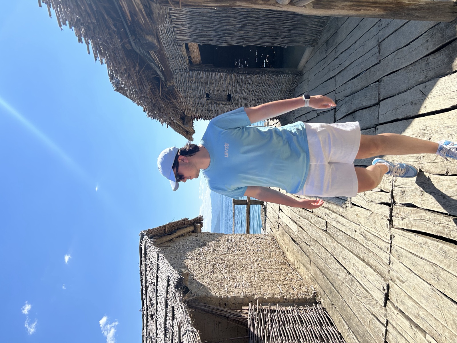 Ben Barkai walking between historic lakeside buildings